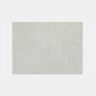 The Marbled Wool Rug is a rectangular, solid light beige area rug with a soft, even texture, shown against a plain white background.