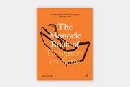 An orange cover book, The Monocle Book of Designers on Sofas, features a minimalist line drawing of a modern sofa and the subtitle: Portraits and profiles of 50 designers and their sofas.