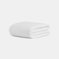 A neatly folded Cocoon Cotton Quilt is displayed on a plain white background.
