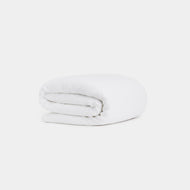 A neatly folded Linen Duvet Cover is displayed against a plain, light background.