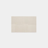 The Paneled Wool Rug is a rectangular, off-white rug featuring a subtle geometric design of textured squares and rectangles, shown on a plain white background.