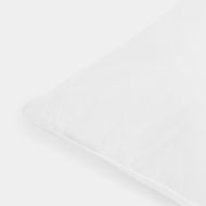 A close-up of the Down Alternative Pillow Insert highlights its smooth, clean white surface against a white background, with only one corner of the pillow visible in the image.