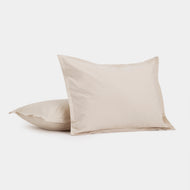 Two Cotton Percale Shams in light beige—one flat, one propped upright—are displayed against a plain white background.