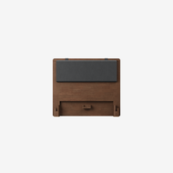 The Essential Headboard features a flat, rectangular wooden frame with a cushioned dark gray upholstered panel near the top. Shown against a plain white background.