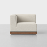 The Essential Sectional Modules feature a modern armless design with cream upholstery and a wooden base, displayed from the side against a plain white background.