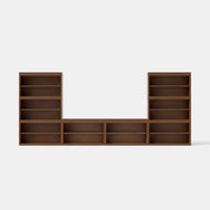 The Nest Media Center, featuring two tall open-shelf sections on each side and three shorter open-shelf sections in the center, is displayed against a plain white background.