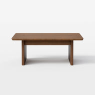 The Square Pillar Coffee Table, featuring a smooth rectangular wooden surface and sturdy, thick legs, is photographed against a plain white background.