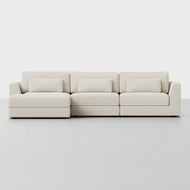 The Signature Chaise Sectional is a modern three-seat sofa in off-white fabric, with clean lines, low arms, and three matching rectangular cushions per seat, shown against a plain white background.