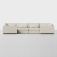 The Signature U Sectional is a modern, modular beige sofa with clean lines and a low-profile design, featuring three seat sections, two corner units, and matching cushions. Shown against a plain white background.