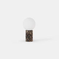 The Stone Accent Lamp features a round white glass shade on a cylindrical dark marble base, shown against a plain white background.