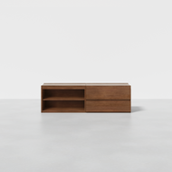 The Nest Media Console is a modern, rectangular wooden sideboard with two open shelves on the left and two closed drawers on the right, displayed on a light gray floor against a plain white background.