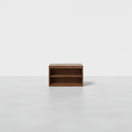 The Nest Nightstand Open is a simple, rectangular wooden unit with two open shelves, shown on a light gray floor against a plain white background.