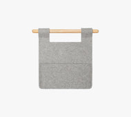 The Felt Sleeve is a gray felt wall organizer with two pockets, hanging from a light wooden rod against a plain white background.