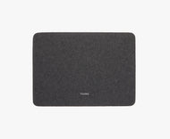 A rectangular dark gray Felt Tops mat with rounded corners and THUMA in white at the center, shown on a plain white background.